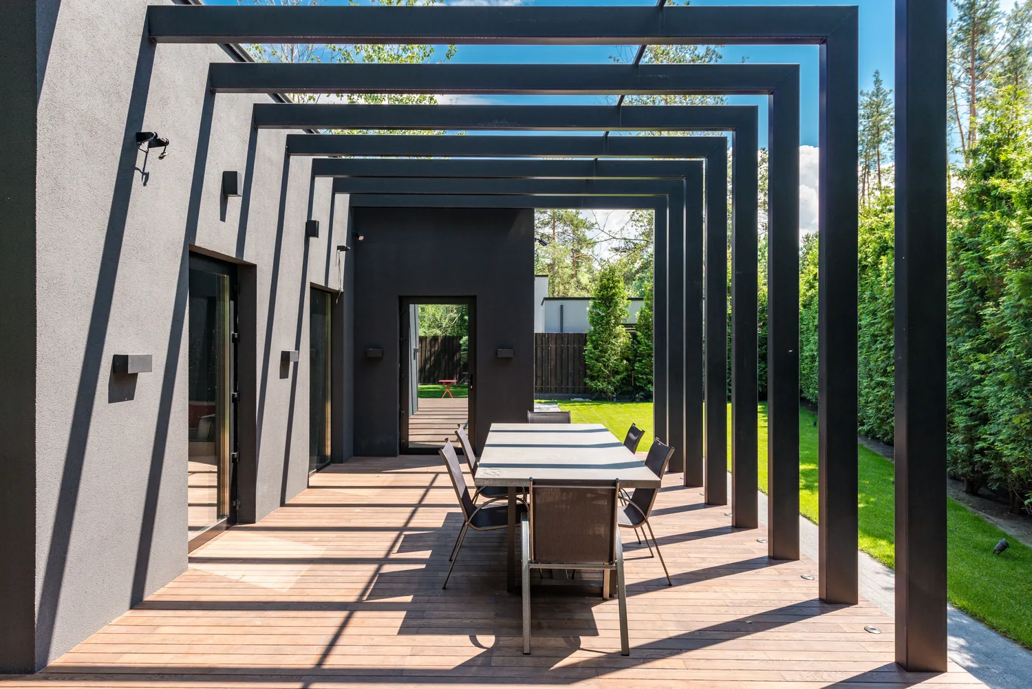 A finished courtyard with a pergola, pool and planting